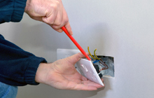 Electrician fitting a plug socket